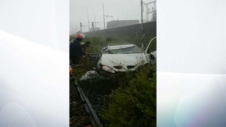 A car lies wrecked after the bridge collapsed