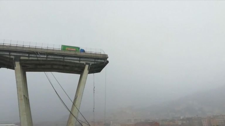 A lorry teeters near the edge after the bridge collapsed