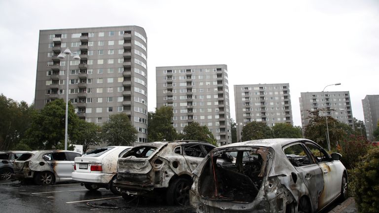Burned cars are pictured at Frolunda Square in Gothenburg