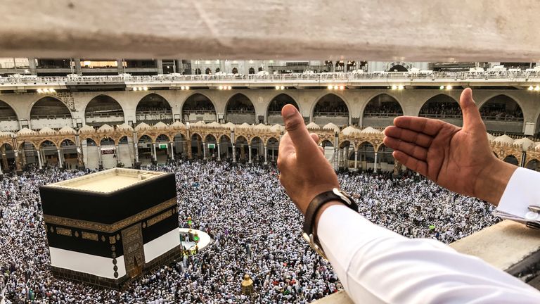 A muslim pilgrim prays while others circle the Kaaba and pray at the Grand mosque ahead of annual Haj pilgrimage in the holy city of Mecca, Saudi Arabia 