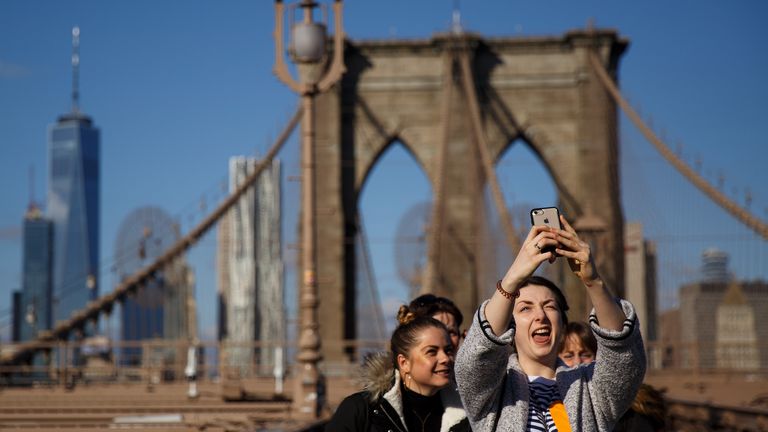 NEW YORK, NY - DECEMBER 01: A group of friends takes a photograph on the Brooklyn Bridge, December 1, 2017 in New York City. The photo-sharing app Instagram has released data for its most-Instagrammed cities and locations for 2017. New York City is ranked number one, with Moscow and London coming in second and third. Among the most photographed locations in New York City were the Brooklyn Bridge, Times Square and Central Park. (Photo by Drew Angerer/Getty Images)
