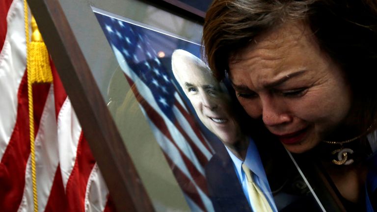 Vietnam-born American citizen Mai Tran mourns John McCain at the US embassy in Hanoi