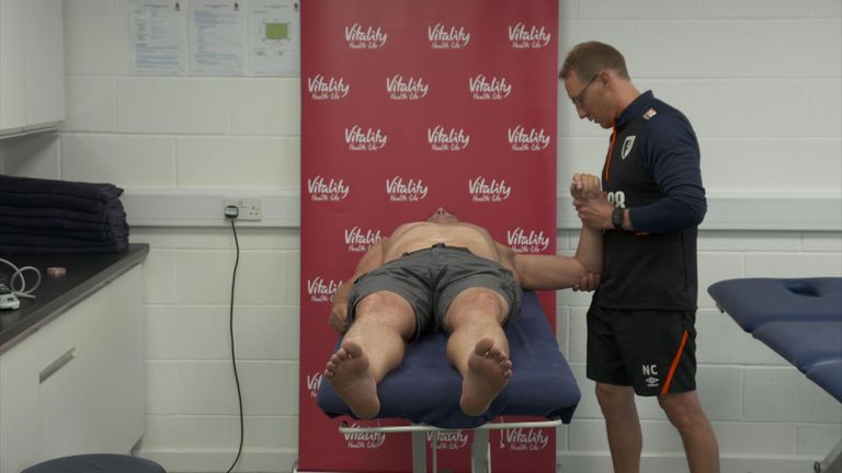 Lewis Pugh receives treatment on his shoulder from medical staff at AFC Bournemouth.
