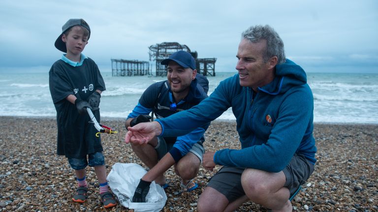 Lewis helps to collect plastic from the beach on day 38