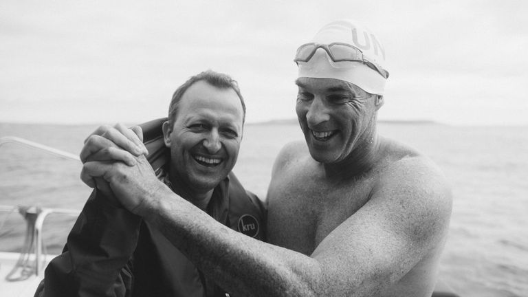 Lewis and friend David Becker celebrate the fast swim