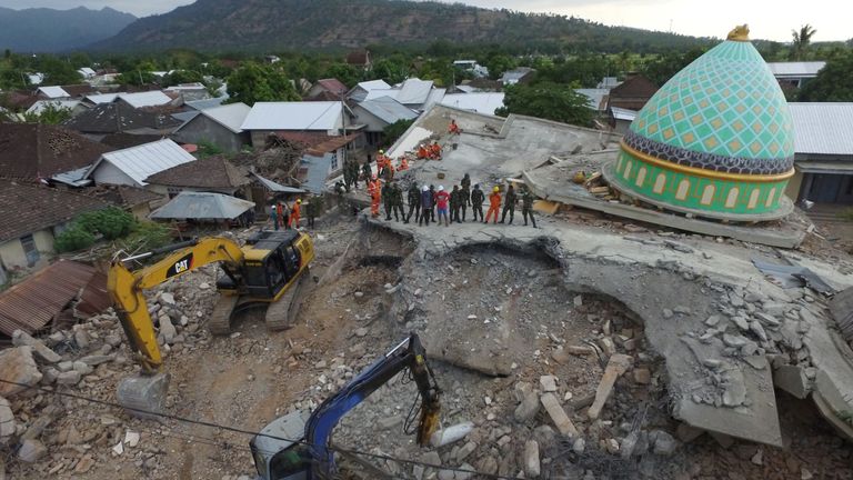 Rescuers search for survivors under the rubble of the Jamiul Jamaah mosque in north Lombok