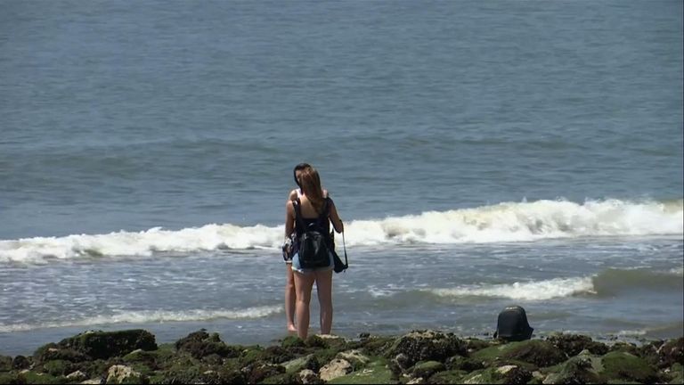 Two women paddle to cool off in the soaring temperatures