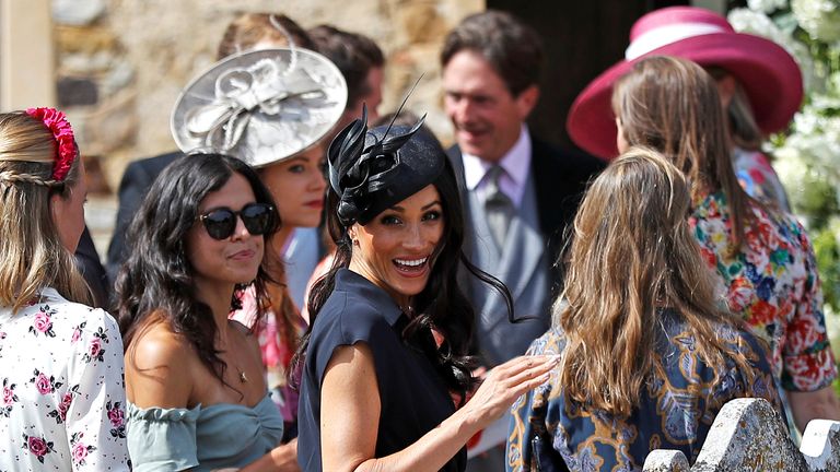 The Duchess of Sussex happily waved to the cameras camped outside the Surrey church