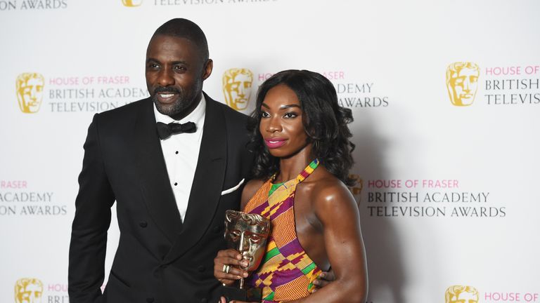 Coel poses with Idris Elba after winning a Bafta for her role in Chewing Gum