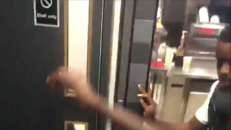 This is the moment two men attack a police officer as he and his colleague try to pin down a suspect on the floor of a McDonald&#39;s.   