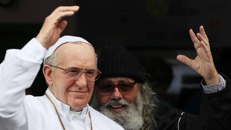 A tourist poses with the waxwork