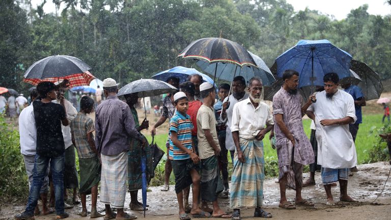 Refugees stand by a road in Kutupaloong refugee camp in Cox&#39;s Bazar, Bangladesh