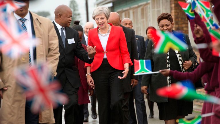 Theresa May is greeted by schoolchildren in Guglethu township, Cape Town