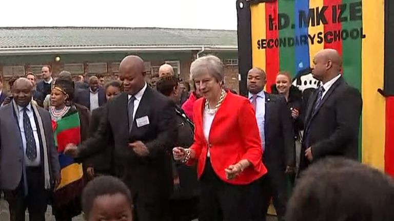Theresa May dances outside a school in Cape Town