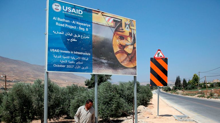 A sign stating that USAID is funding the al Badhan road project