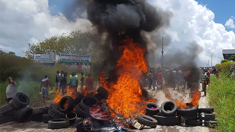 Residents of the Brazilian border town of Pacaraima burn tyres and belongings of Venezuelans immigrants after attacking their two main makeshift camps