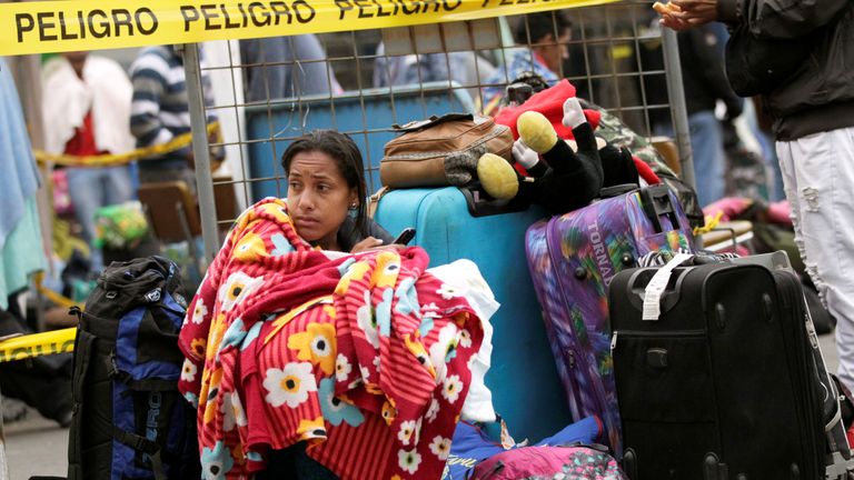 A Venezuelan migrant waits in line to register their entry into Ecuador, at the Rumichaca International Bridge