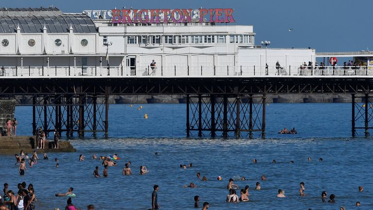 Beachgoers cool down in the sea during hot weather at Brighton in southern Britain, August 3, 2018. REUTERS/Toby Melville