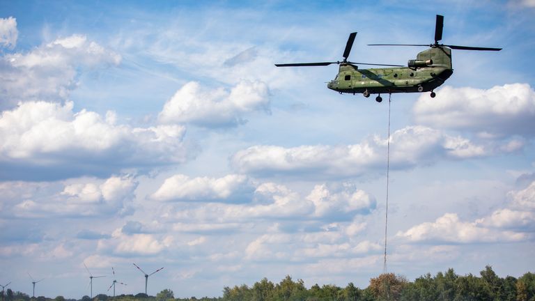A helicopter seen collecting water from a lake to fight forest fires near Straelen, western Germany. It has peaked at 33C (91.4F) there today.

