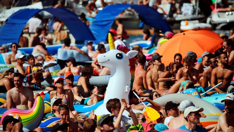 Crowds at the finals of the Red Bull Cliff Diving series in Sisikon, Switzerland, are trying their best to keep cool

