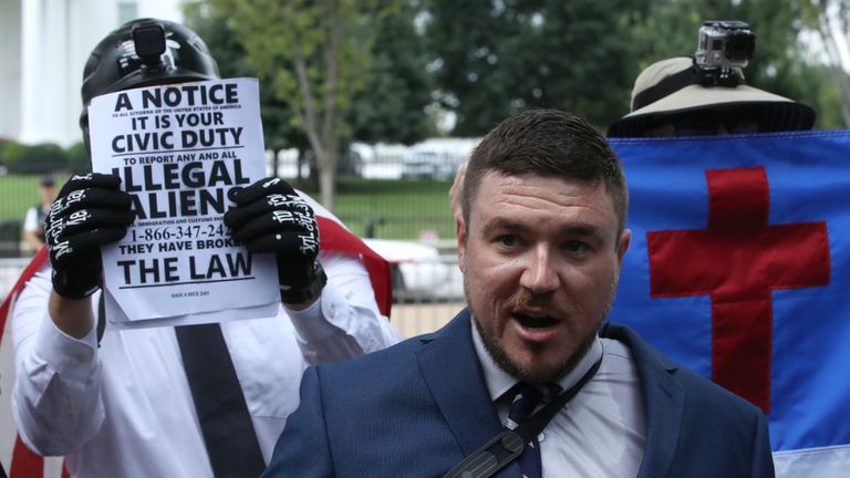 Surrounded by his supporters, Jason Kessler (C) sets off for his white supremacist &#39;Unite the Right&#39; rally