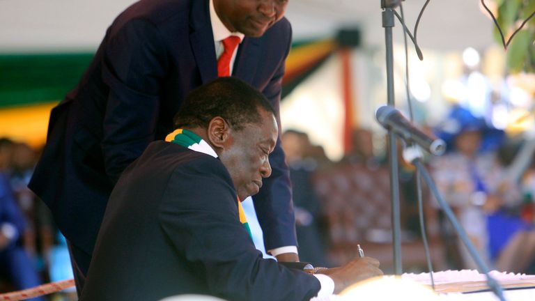 Mr Mnangagwa signs during his inauguration ceremony                