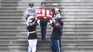 A Military Honour Guard carries Senator McCain&#39;s coffin