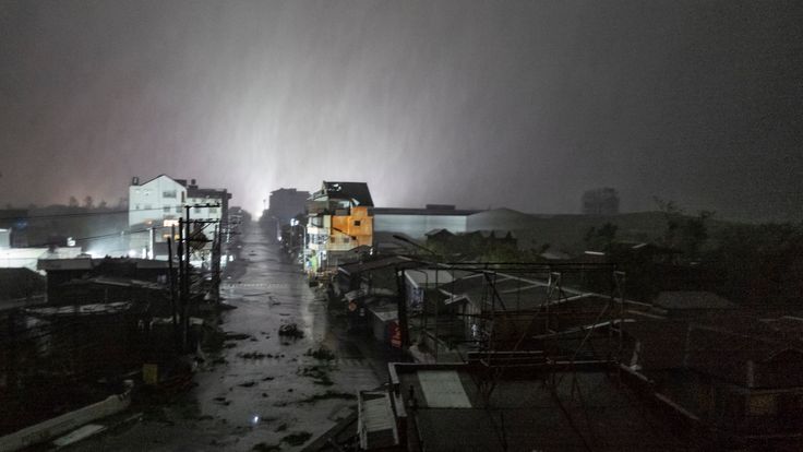 Rains cover the city as strong winds batter houses and buildings lying on the path of Typhoon Mangkhut as it makes landfall on September 15, 2018 in Tuguegarao city, northern Philippines