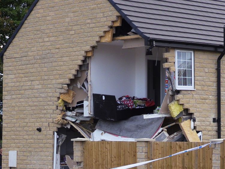 A bedroom in the house has been fully exposed by the collision