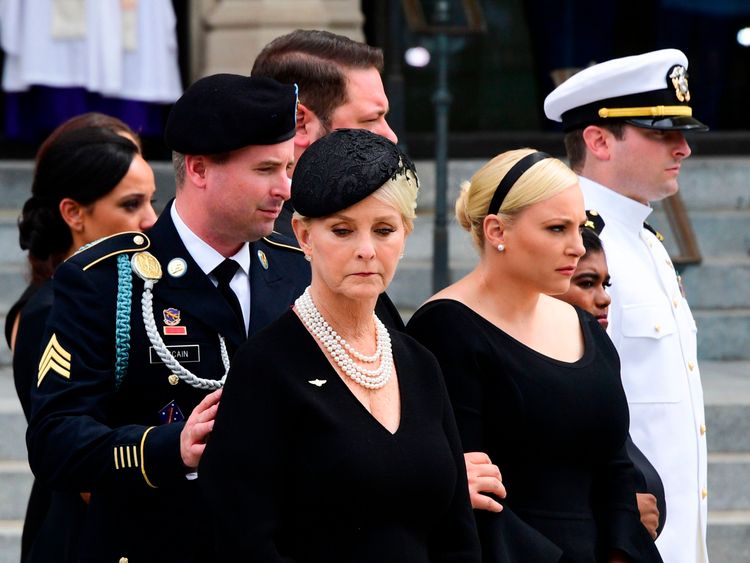 Cindy McCain (C) the widow of US Senator John McCain and her sons and daughters look on after a Military Honor Guard placed the casket of US Senator John McCain into a hearse at the end of his memorial service for at the Washington National Cathedral in Washington, DC, on September 1, 2018. (Photo by JIM WATSON / AFP) (Photo credit should read JIM WATSON/AFP/Getty Images) 