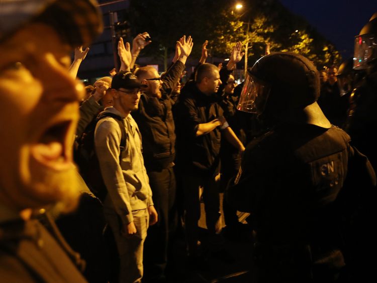 Far-right protesters shout and raise their arms in Chemnitz