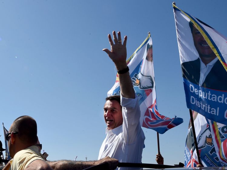 Brazilian right-wing presidential candidate Jair Bolsonaro waves at the crowd during a campaign rally 