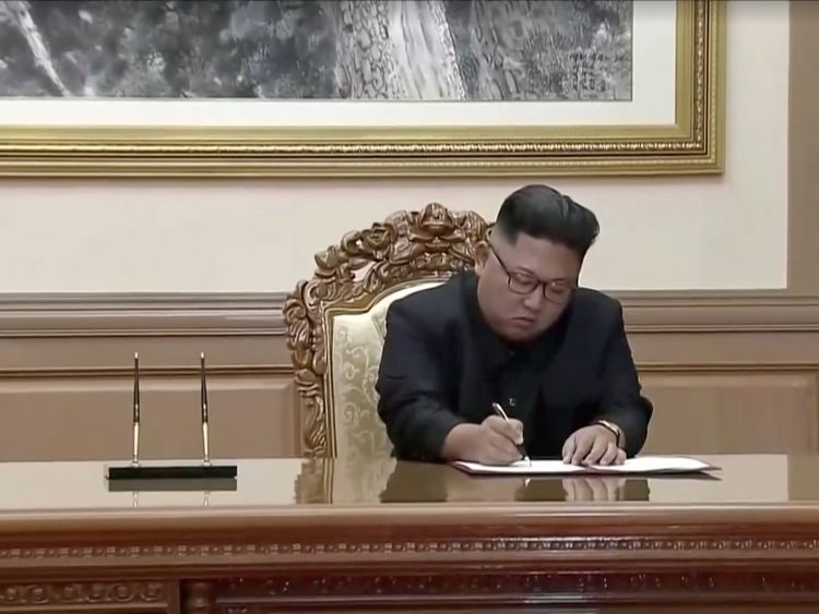 Kim Jong Un signs documents during the summit with South Korea&#39;s leader