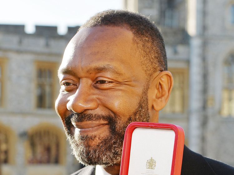 British actor Lenny Henry with his Knighthood after he was presented with it by Britain&#39;s Queen Elizabeth during an Investiture ceremony at Windsor Castle in Windsor, west of London on December 4, 2015