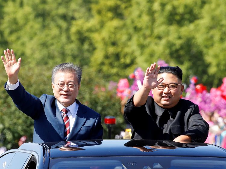 South Korean President Moon Jae-in and North Korean leader Kim Jong Un wave during a car parade in Pyongyang, North Korea