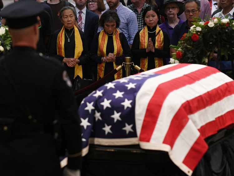 Mourners file past the casket of Senator McCain who lies in state in the Rotunda at the U.S. Capitol...