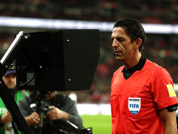 Referee Deniz Aytekin checks the VAR during the England-Italy friendly at Wembley in March