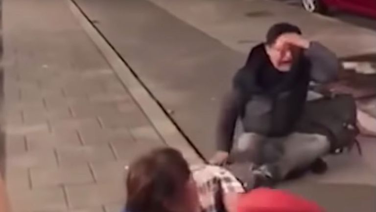 A Chinese man and a woman are seen wailing in the clip