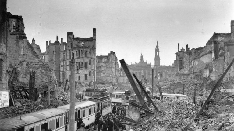 Germans board trams in the midst of ruins left by an Allied air raid on Johannstrasse, Dresden
