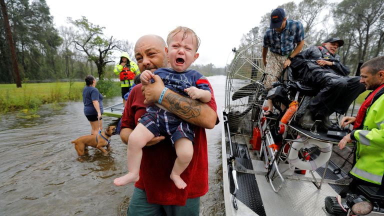 Oliver Kelly, 1 year old, cries as he is carried off the sheriff&#39;s airboat during his rescue from rising flood waters in the aftermath of Hurricane Florence in Leland, North Carolina