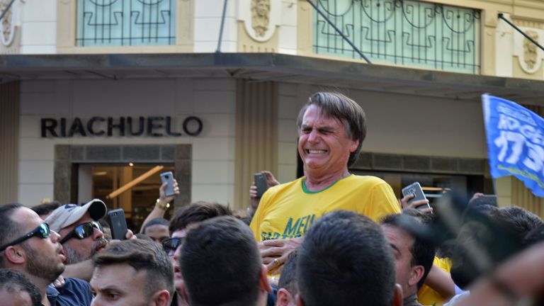 Brazilian right-wing presidential candidate Jair Bolsonaro gestures after being stabbed in the stomach