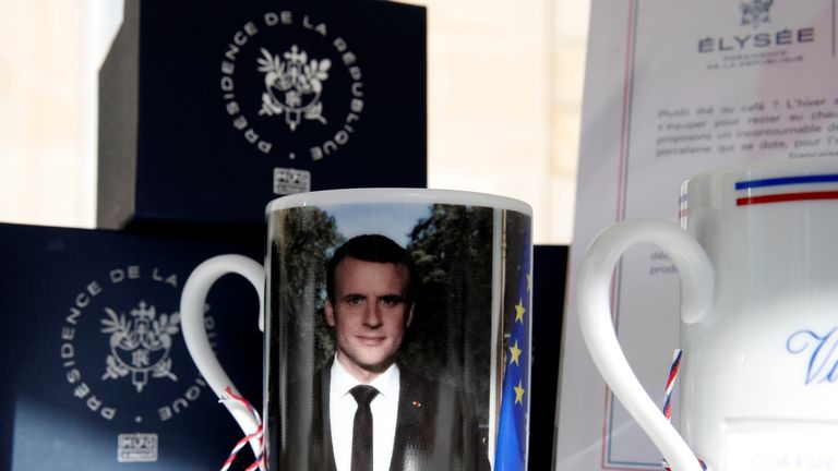 A mug with a picture of French President Macron and the Elysee Palace logo in the courtyard of the Elysee Palace 