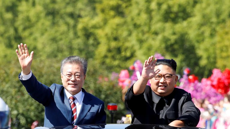 South Korean President Moon Jae-in and North Korean leader Kim Jong Un wave during a car parade in Pyongyang, North Korea