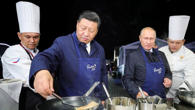 Russian President Vladimir Putin and Chinese President Xi Jinping make pancakes during a visit to the Far East Street exhibition on the sidelines of the Eastern Economic Forum in Vladivostok, Russia September 11, 2018. 