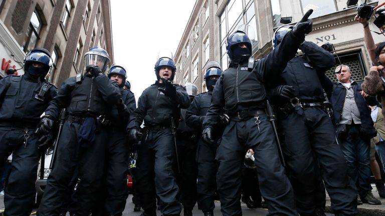 Police officers form a cordon after raiding a building used as a base for demonstrators protesting against the upcoming G8 summit in central London June 11, 2013
