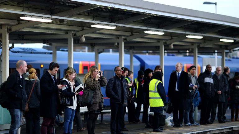 LONDON, ENGLAND - JANUARY 02:  Passengers wait on a platform at Clapham Junction on January 2, 2014 in London, England. Increased rail fares averaging 2.5% come into effect today, pushing the cost of some commuters annual rail fares to more than ..5,000. Earlier this week, Network Rail chief executive Mark Carne said that he would not be receiving his annual bonus because of the major rail disruption passengers faced over the Christmas period, which was caused by engineering works that overran.  (Photo by Dan Kitwood/Getty Images)