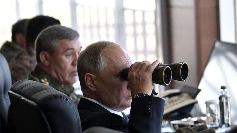 Russian President Vladimir Putin uses a pair of binoculars as he watches the Vostok-2018 (East-2018) war games