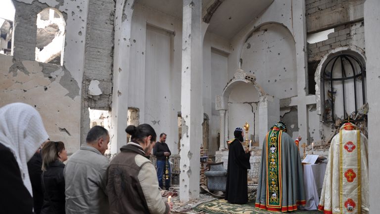 A Christian Syriac patriarch holds mass at a heavily damaged church in Deir Ez Zor in February 2018