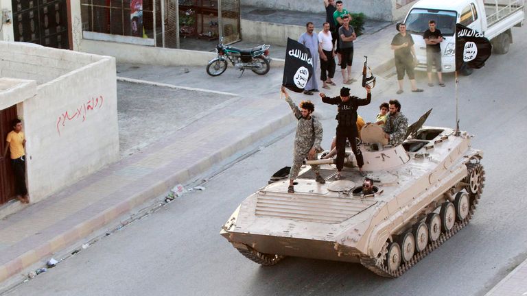 Islamic State fighters take part in a military parade in Raqqa province in June, 2014