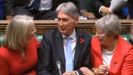 Chief Secretary to the Treasury Liz Truss (left) and Prime Minister Theresa May congratulate Chancellor of the Exchequer Philip Hammond as he finishes making his Budget statement to MPs in the House of Commons, London.
